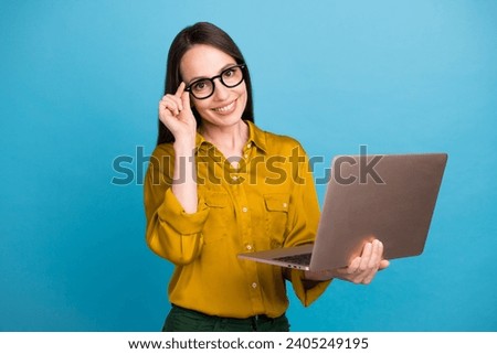 Photo of sweet smart woman dressed yellow shirt hand arm eyewear texting apple samsung modern device isolated blue color background