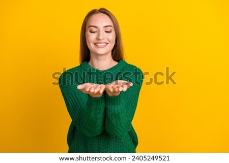 Portrait of young smiling girl model enjoy winter holidays vibes with xmas decoration holding arms isolated on yellow color background