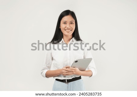 Photo of young asian ceo manager, working woman holding tablet and smiling, standing over white background