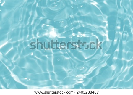 Bluewater waves on the surface ripples blurred. Defocus blurred transparent blue colored clear calm water surface texture with splash and bubbles.