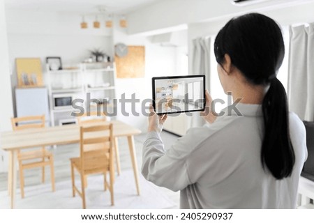 A woman using an AR app to simulate furniture placement