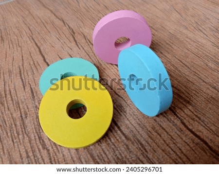 Small children's toys are round and colorful like donuts