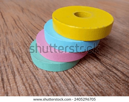 Small children's toys are round and colorful like donuts