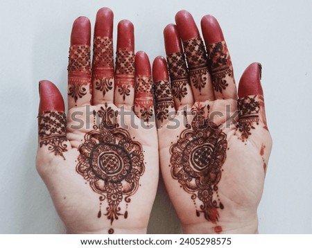 palms using red henna with a simple motif for the wedding day