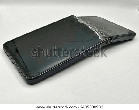 Smartphone with broken screen isolated on white background.
