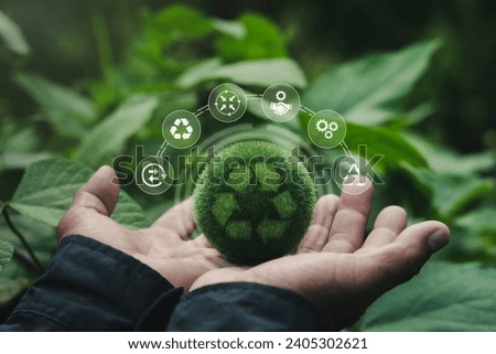 Green globe in man's hand with recycling symbol With icons about recycling, recycling concepts, reducing waste for a sustainable environment. Including helping to reduce carbon. Royalty-Free Stock Photo #2405302621