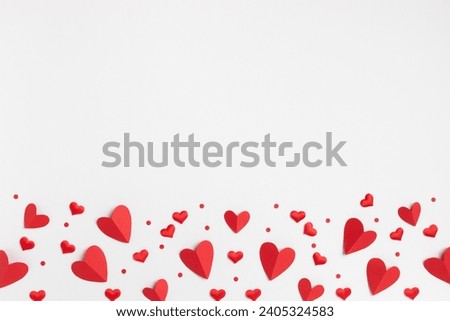 Valentine or Mother day festive greeting card border from various mixed red hearts on white background top view and flat lay.