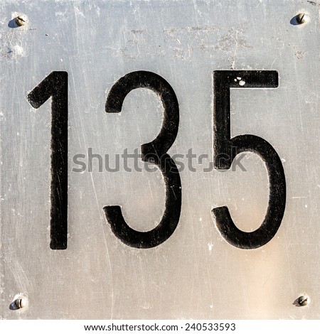 House number one hundred and thirty five, engraved in an aluminum plate.