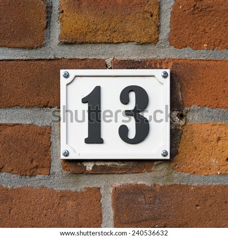 House number Thirteen. Black lettering on a white background
