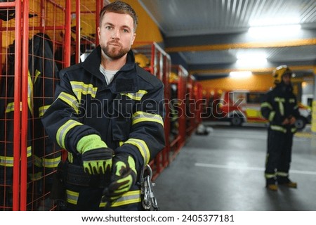 Young handsome fireman in the fire department.