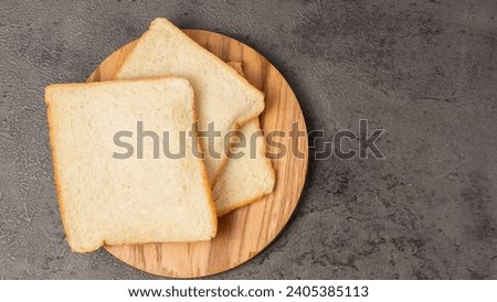 Slices of white bread on a wooden board