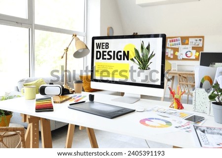 Interior designer's workplace with computer and graphic tablet in office