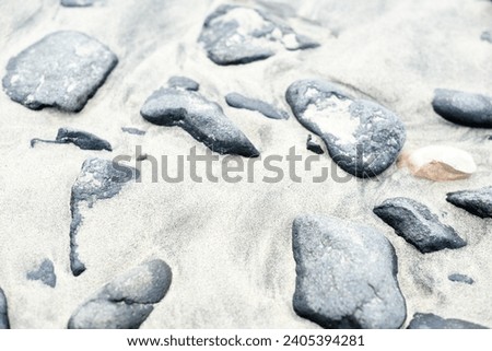 Marble grey stones in white sand beach holiday vibes Spain Fuerteventura Canary Islands creative wallpaper texture background