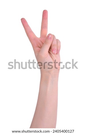 Hand is isolated on a white background, showing two fingers. The number "two" in sign language. Royalty-Free Stock Photo #2405400127