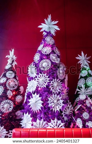 Christmas decoration background texture with origami styles hanging on the tree.