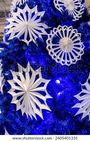 Christmas decoration background texture with origami styles hanging on the tree.