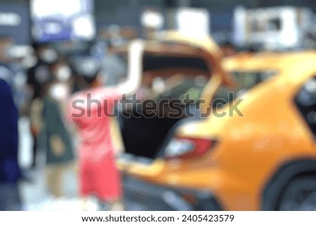 Royalty high quality free stock photo of abstract blur and defocused boy is open the trunk of the car at car and motor exhibition show event