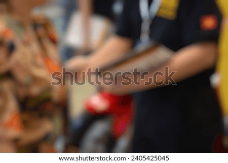 Royalty high quality free stock photo of abstract blur and defocused A man is handing out flyers at car and motor exhibition show event