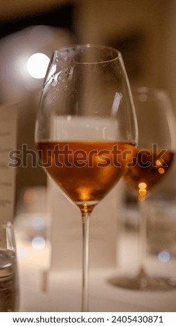 detailed wine glass with a desert wine in deep orange colour Royalty-Free Stock Photo #2405430871