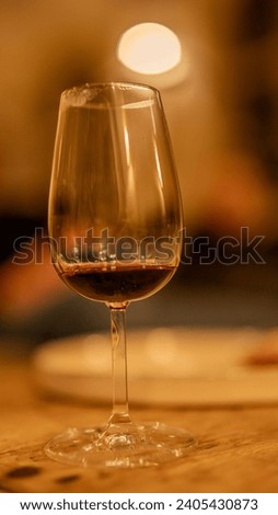 detailed wine glass with a desert wine in deep orange colour Royalty-Free Stock Photo #2405430873