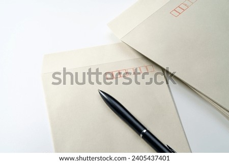 Envelope and pen on white background Royalty-Free Stock Photo #2405437401