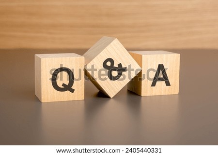 text q and a on wooden blocks against brown background with copy space. concept of sale and discount. Royalty-Free Stock Photo #2405440331