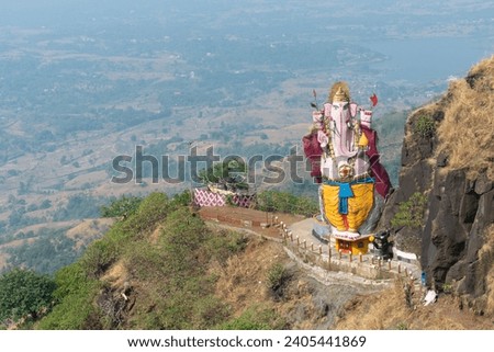 Lord Ganesha's Idol 
made of rock near Matheran, Maharashtra. Hinduism, sanatan, economics, India, Indian, Ganesh Chaturthi, pilgrimage, spiritual, religious, people, peace, nature, toy train, holiday Royalty-Free Stock Photo #2405441869