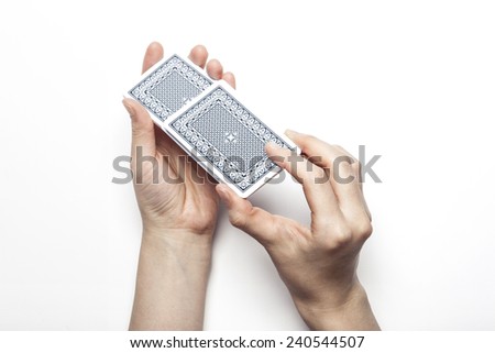 A female(woman) hand hold trump card(back side) isolated white background at the studio.