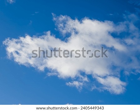 Fluffy white cumulus and stratus clouds in blue sky