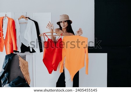 A woman in a locker room tries on clothes