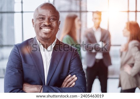 Handsome african american executive businessman in modern office Royalty-Free Stock Photo #2405463019