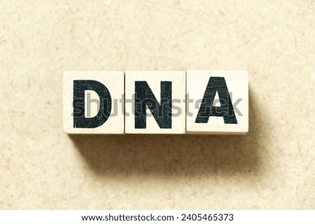 Alphabet letter block in word DNA (abbreviation of Deoxyribonucleic acid) on wood background Royalty-Free Stock Photo #2405465373