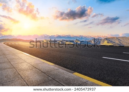 Asphalt highway road and green mountain with sky clouds at sunset