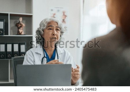Doctor and patient are discussing something, just hands at the table at clinic.