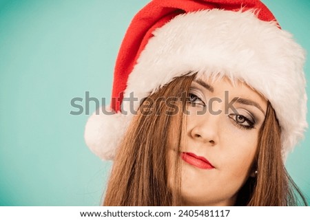 Tired sad woman wearing santa hat. Female with lack of energy. Christmas time.