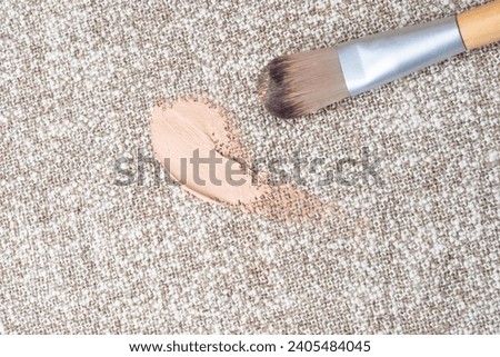 Foundation stains on the white upholstery of the couch or carpet. daily life stain and cleaning concept. top view. High quality photo
