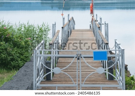 Pier near the small port of the lake. Royalty-Free Stock Photo #2405486135