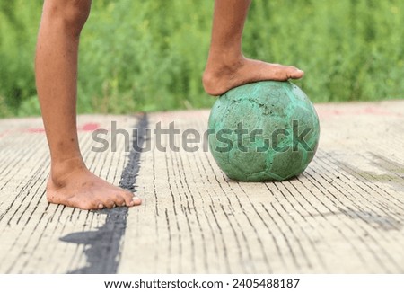 boy's foot stepped on a plastic ball. sport concept, football