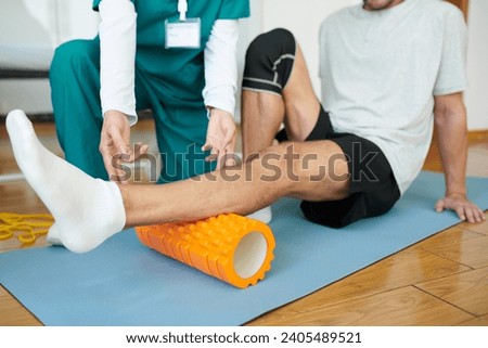 Patient or rehabilitation center using myofascial roll to release muscle tension in calf