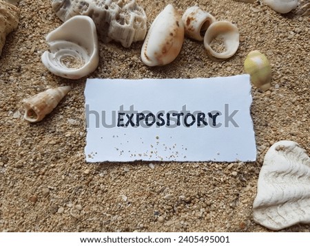 Expository writing on beach sand background.