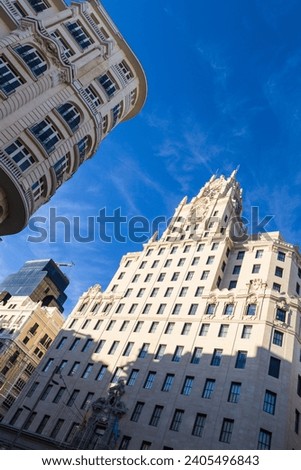 Madrid, Spain - 23 November 2022: Telefonica Building in Gran Via Street. Dutch angle (Dutch tilt, canted angle, or oblique angle) Royalty-Free Stock Photo #2405496843