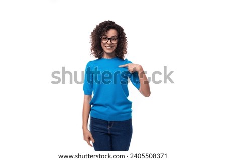 young cheerful curly woman with black hair dressed in a blue corporate t-shirt with print mockup