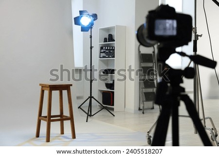Camera, stool and different equipment for casting in studio, selective focus