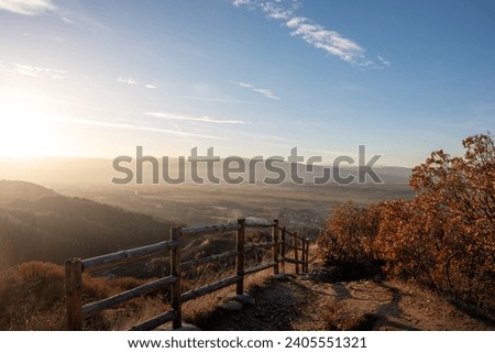 Serene Splendor: A Breathtaking Sunset Over Majestic Mountains and a Wooden Bridge in Nature's Embrace