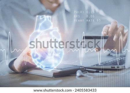 Double exposure of man hands holding a credit card and human heart drawing. Medical education and E-commerce concept.