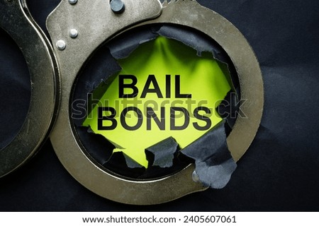 Bail bonds inscription and handcuffs. Royalty-Free Stock Photo #2405607061