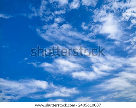 Many glowing clouds spreading on the deep blue sky in winter days. Small soft white fluffy clouds covered the blue sky. Elegant white thin clouds texture, abstract background. Landscape photo