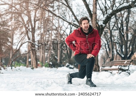 Ouch, I hurt my back! Man exercising outdoors, having backache while doing lunges or stretching. Royalty-Free Stock Photo #2405624717