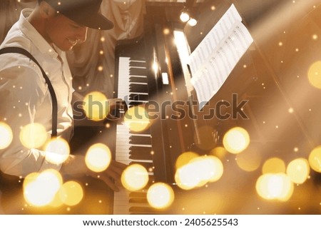 Christmas and New Year music. Man playing piano, bokeh effect