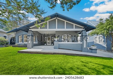 The front view of a home with a yard  Royalty-Free Stock Photo #2405628683